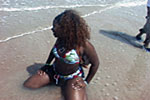 Girl plays in the water at the beach