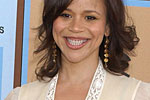 Rosie Perez in tan low cut top